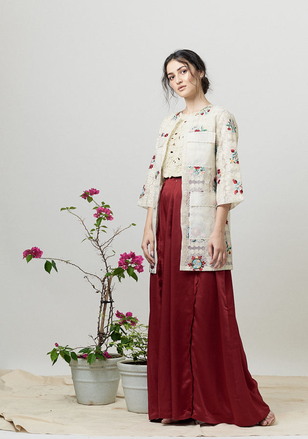 Red satin flared pants with scallop detailing